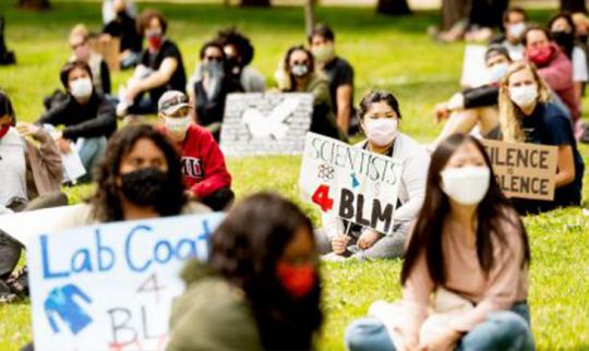 Scientists with BLM signs