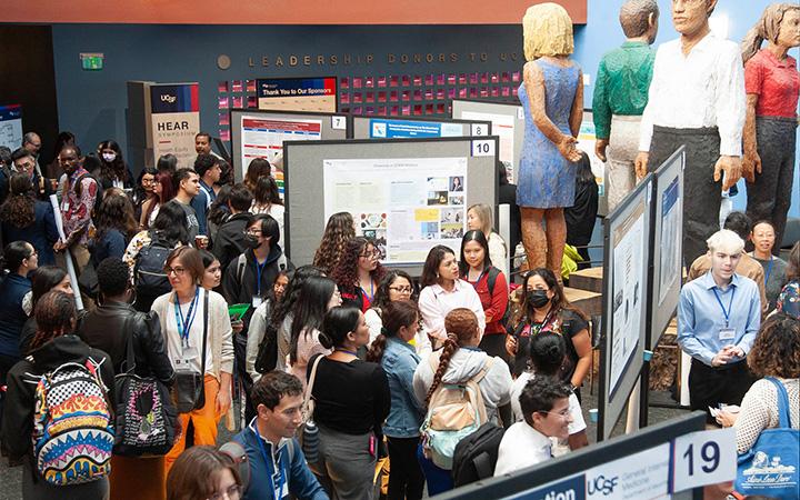 Participants of the 2024 HEAR Symposium are gathered in the poster presentation hall